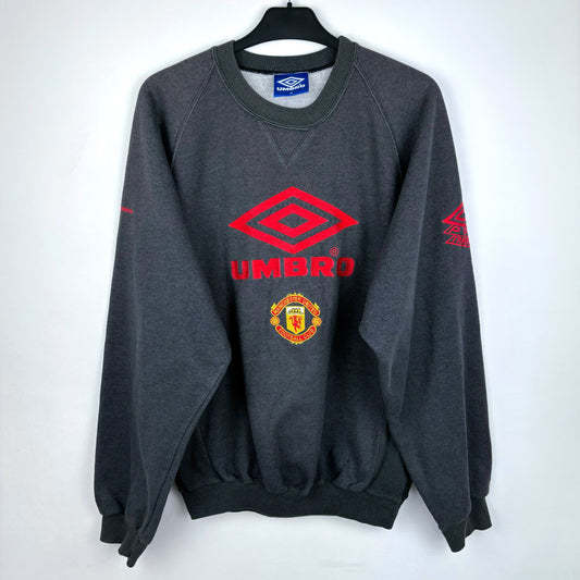 Front view of 1992-1994 Manchester United grey Umbro sweatshirt – vintage football shirt style with classic Umbro logo and Manchester United crest, ideal for fans of retro soccer jerseys and football classics shirts.