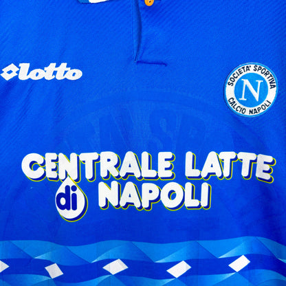 Close up of badges and sponsor on Napoli 1996-1997 Lotto home classic football jersey. Blue body with sublimated pattern. Centrale Latte di Napoli sponsor.