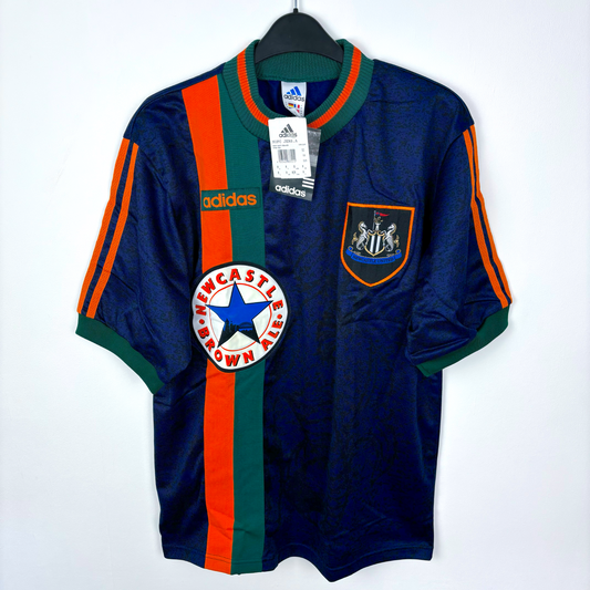 Newcastle United classic football shirt produced by Adidas. Navy body featuring duel green and orange stripes and crew neck collar.