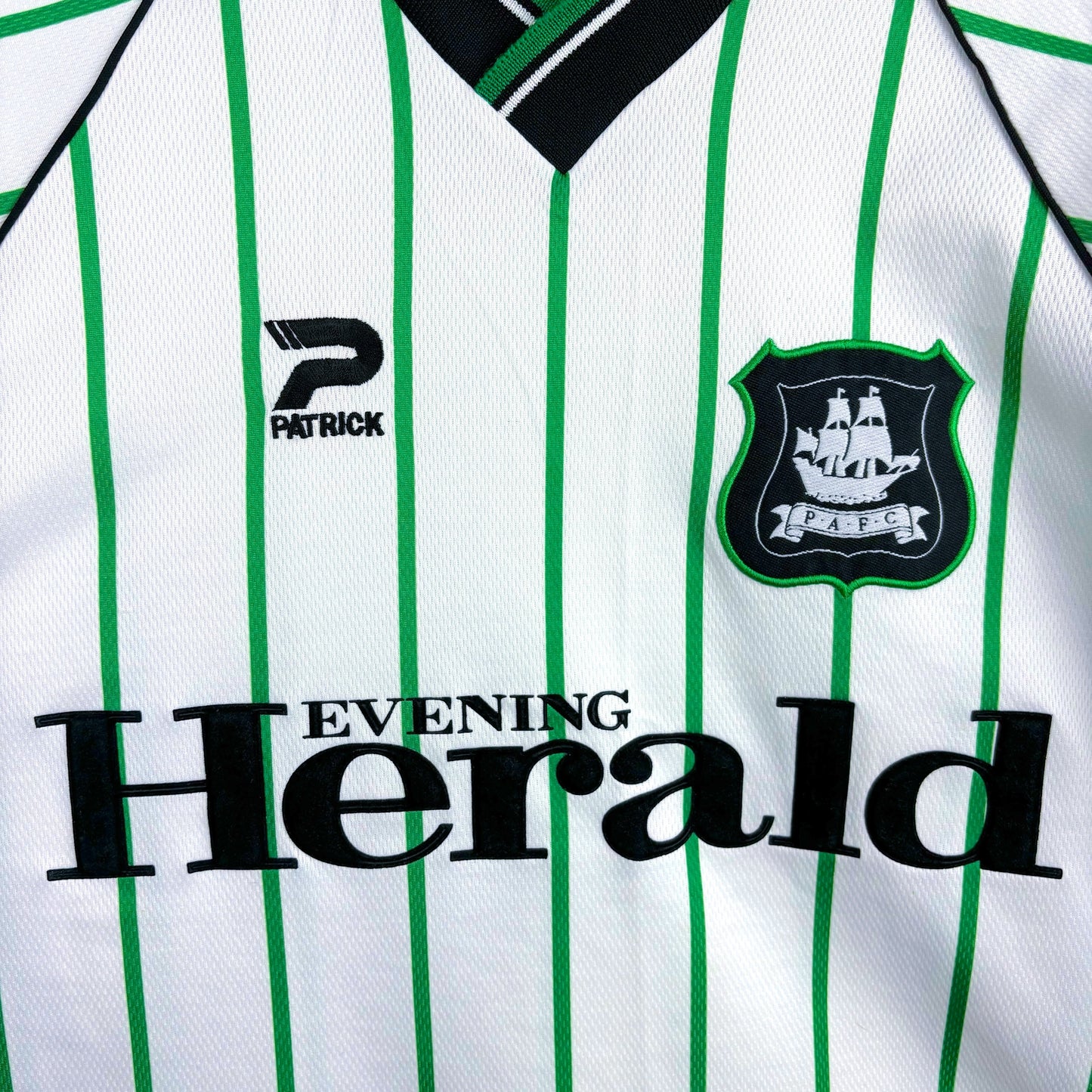 Plymouth Argyle 2000-2001 Admiral vintage football shirt white body and green pinstripes. Close up of Evening Herald sponsor and club badge..
