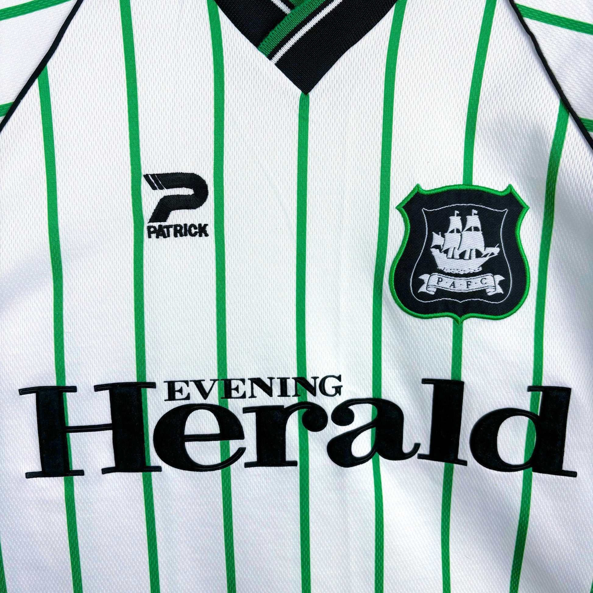 Plymouth Argyle 2000-2001 Admiral vintage football shirt white body and green pinstripes. Close up of Evening Herald sponsor and club badge..