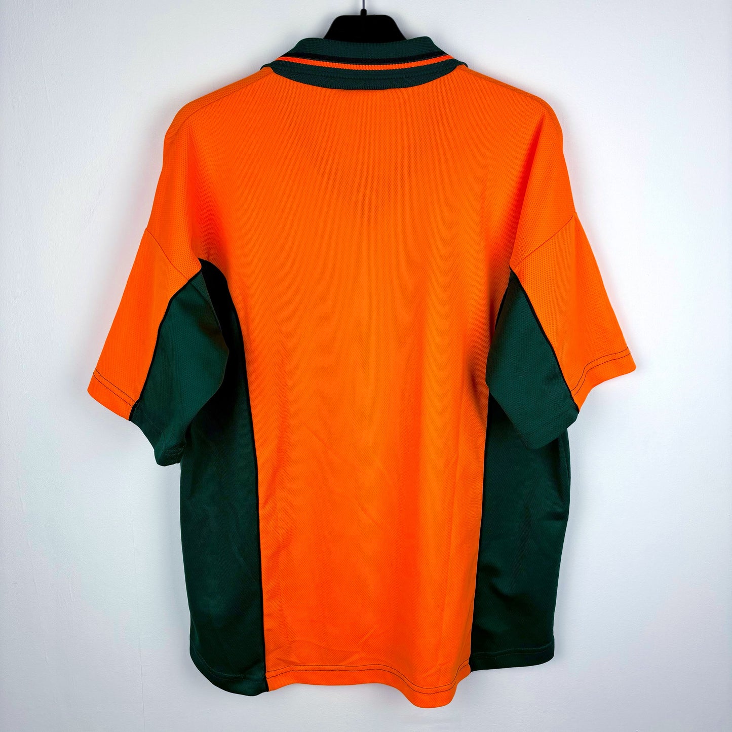 Rear view of Plymouth Argyle 2002-2003 Patrick away vintage football shirt. Orange body with green trim. Ginsters sponsor.