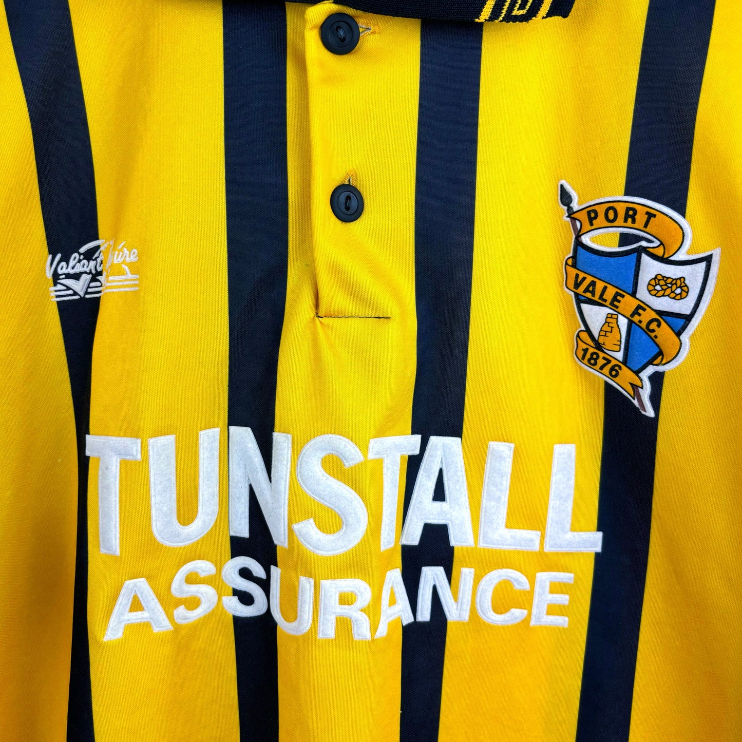 Close up of Tunstall Assurance sponsor. Port Vale 1993-1994 Vale Leisure retro football shirt with yellow body and black stripes.
