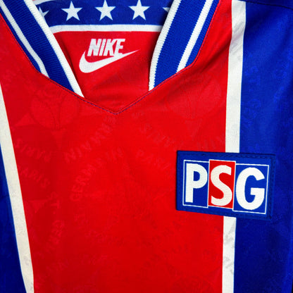 Close up of club badge on PSG 1994-1995 Nike home classic football shirt. Long-sleeved blue body with central red vertical stripe and white trim.