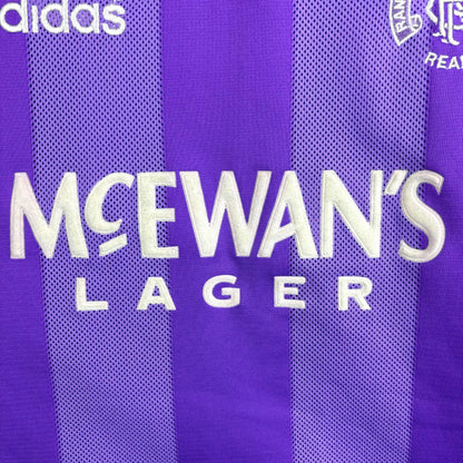 Close up of McEwan's Lager sponsor on Rangers 1994-1995 adidas European retro football shirt in lilac with black collar.