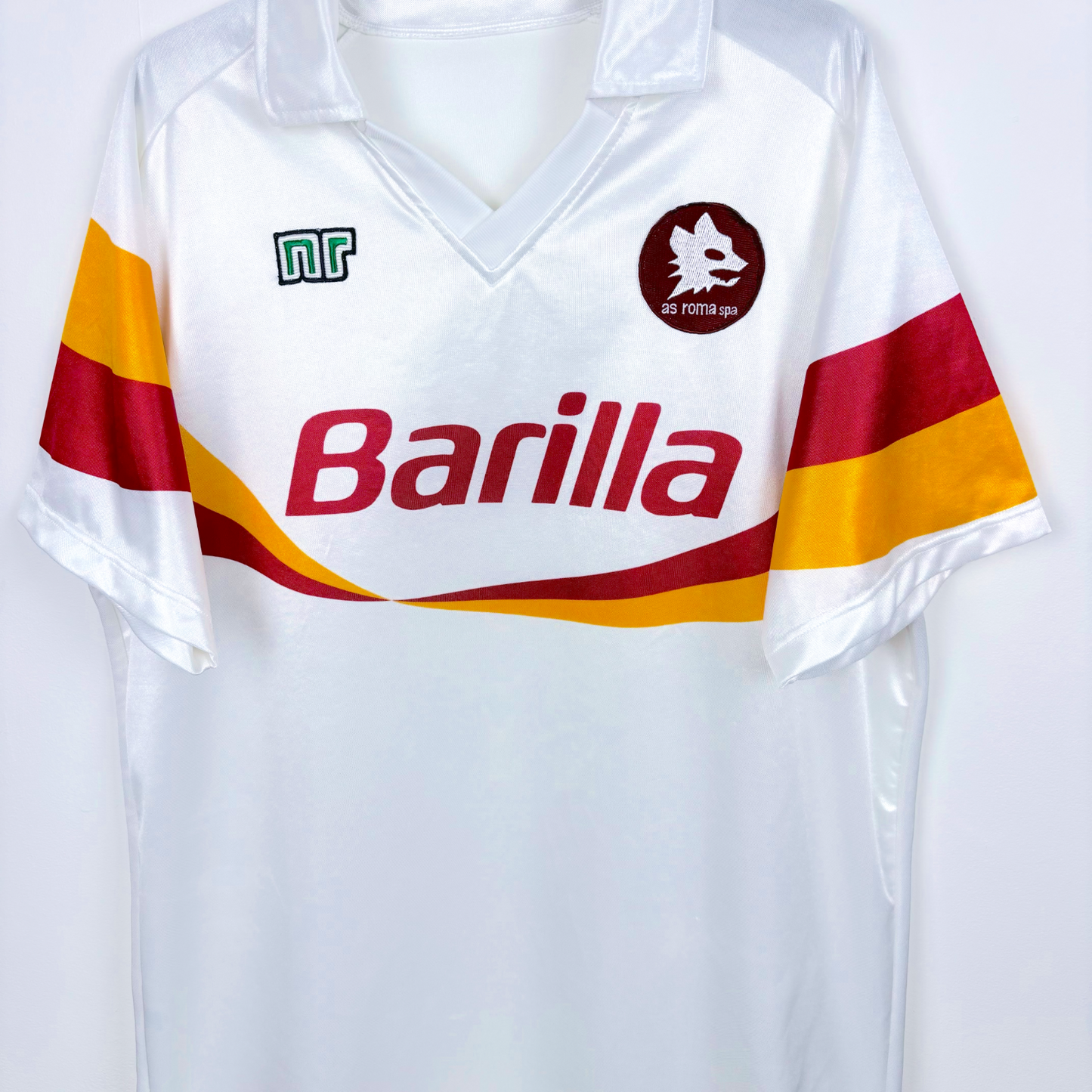Roma vintage football shirt made by Ennerre. White body featuring orange and maroon swoosh across chest and sleeves. Sublimated Barilla sponsor