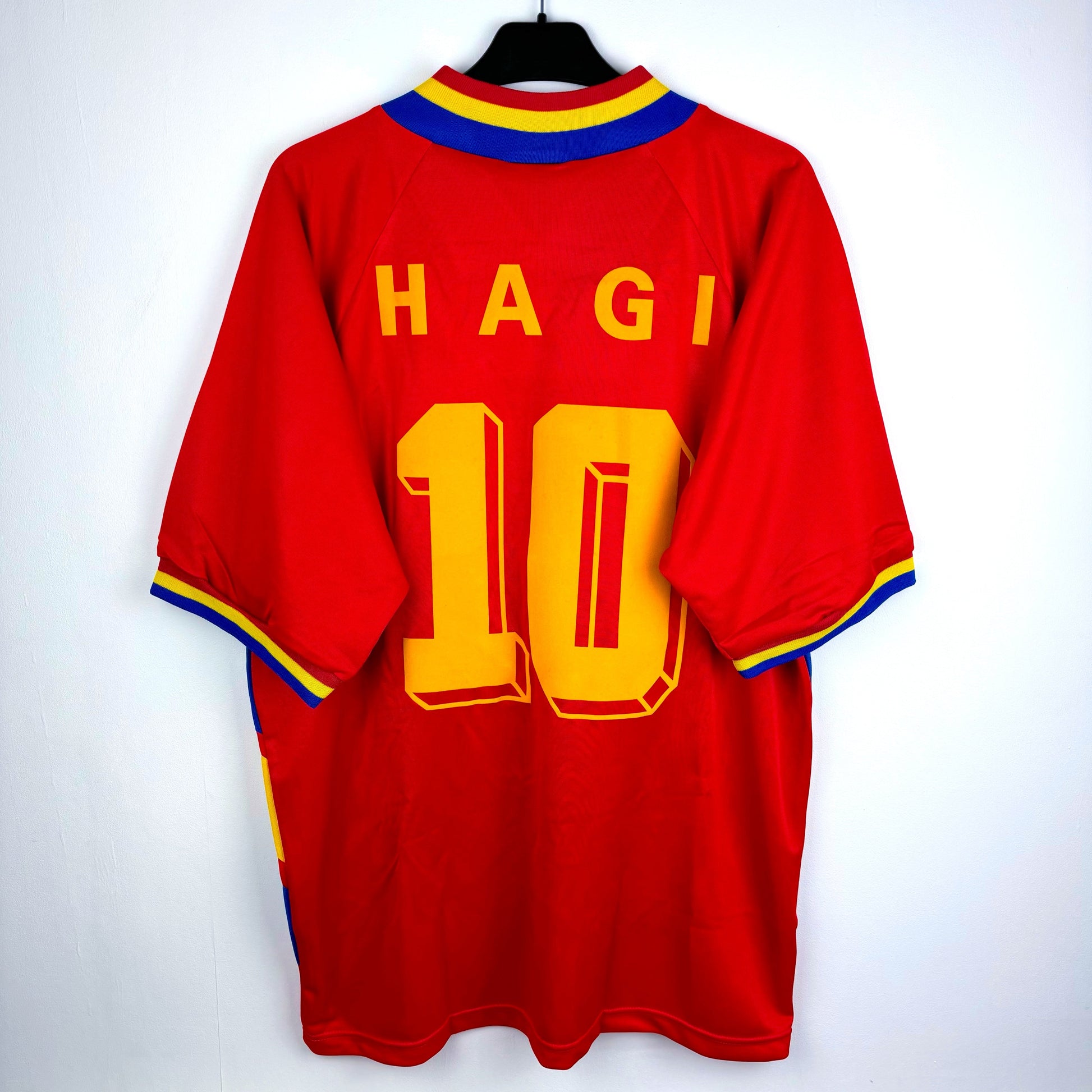 Romania 1994-1995 adidas away classic soccer jersey. Red body with blue and yellow trim. Rear view depicting Hagi nameset and number 10 in yellow.